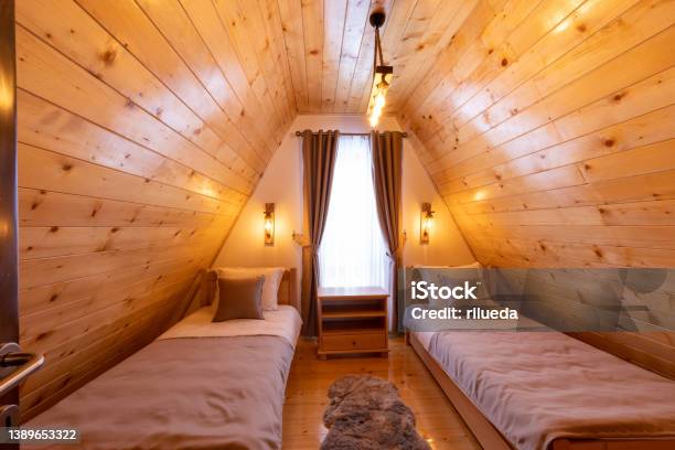 Interior Of A Wooden Mountain House Attic Two Bed Bedroom Stock Photo - Download Image Now