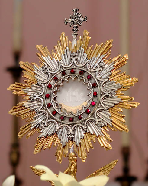 istock Eucharist (Blessed Sacrament) inside the Monstrance (Ostensory) during Eucharistic adoration. The Host bears the inscription JHS, monogram of Jesus's 1389654849
