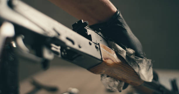 istock Man cleaning the AK-47 gun, disassembling and preparing to use. Close up on hands 1389654925