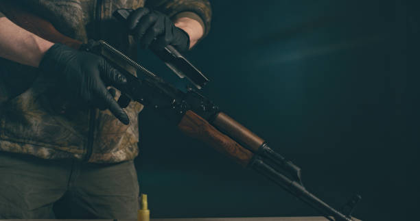 istock Soldier cleaning the AK-47 gun, disassembling and preparing to use. Close up on hands 1389654933