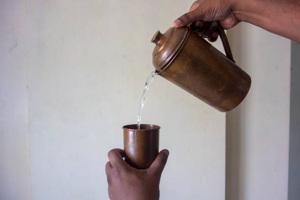 istock Water pouring from jug into glass 1389655054