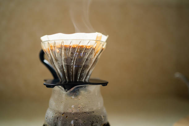 istock Coffee dripper and carafe with steam 1389655103