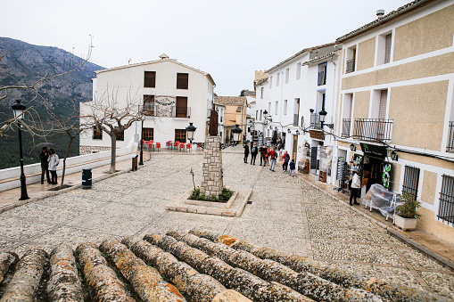 Guadalest, Alicante, Spain- November 26, 2021:Main Square with beautiful views and whitewashed facades of the town of Guadalest in Alicante, Spain
