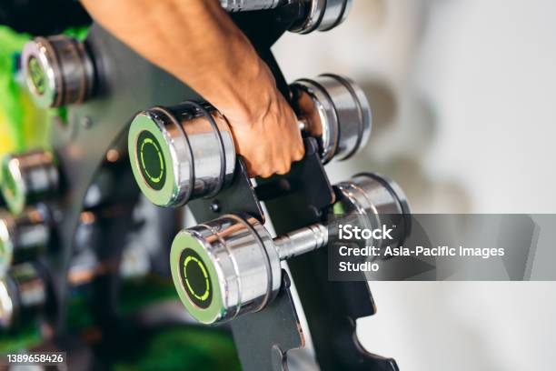 Close Up Of Unrecognizable Man Taking Dumbbells In A Gym Health And Fitness Concept Stock Photo - Download Image Now