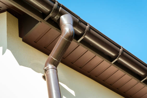 istock Brown pvc gutter connected to downpipe on roof edge. 1389659016