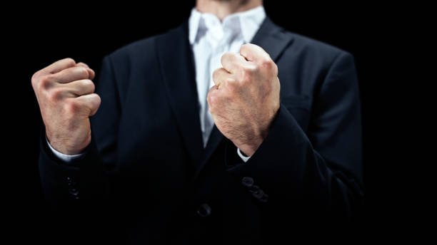 Close-up of businessman clenching fist.