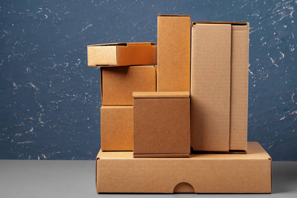 istock Group of cardboard boxes against blue background 1389664395