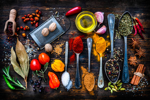 Spices, herbs and vegetables shot from above on rustic dark table. High resolution 42Mp studio digital capture taken with SONY A7rII and Zeiss Batis 40mm F2.0 CF lens