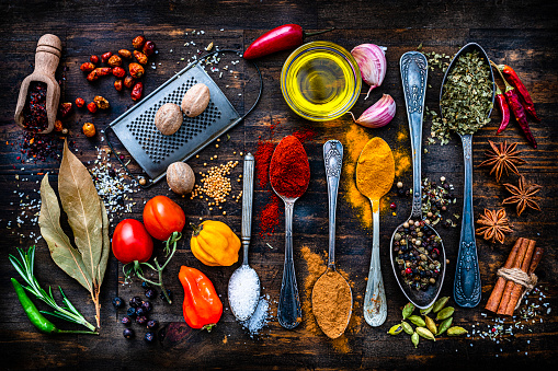 Spices, herbs and vegetables shot from above on rustic dark table. High resolution 42Mp studio digital capture taken with SONY A7rII and Zeiss Batis 40mm F2.0 CF lens