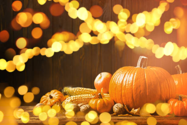 istock Composition with ripe pumpkins on wooden table, bokeh effect. Happy Thanksgiving day 1389666162