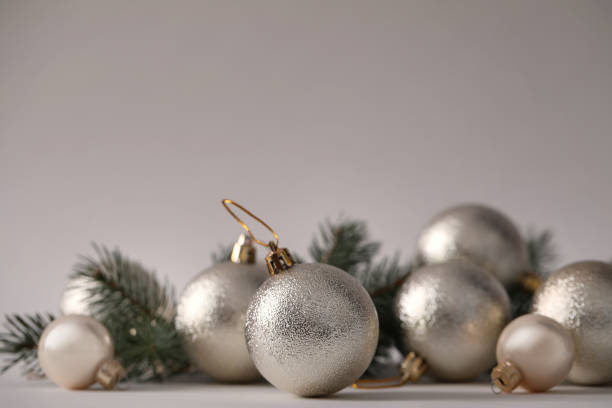 istock Beautiful Christmas balls and fir branches on grey background. Space for text 1389666407