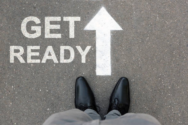 istock Text Get Ready and arrow on asphalt in front of man, top view 1389666590