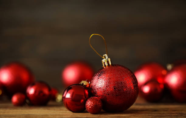 Many beautiful Christmas balls on wooden table