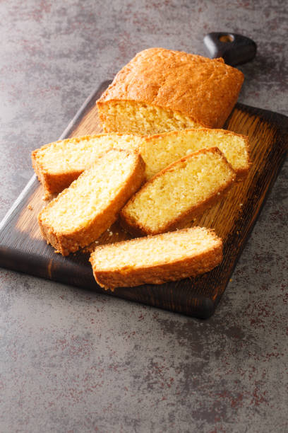 istock Sliced Madeira Cake closeup on a wooden cutting board. Vertical 1389668319