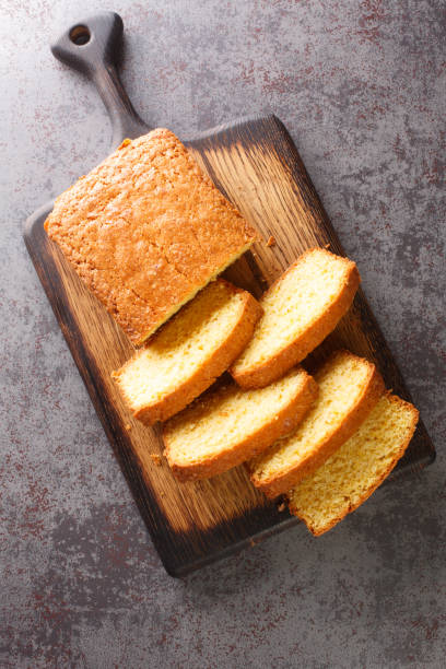 Sliced Madeira Cake closeup on a wooden cutting board. Vertical top view Sliced Madeira Cake closeup on a wooden cutting board on the table. Vertical top view from  above pound cake stock pictures, royalty-free photos & images