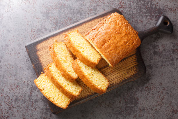 Delicious tender Madeira biscuit cake close-up on a wooden board. horizontal top view Delicious tender Madeira biscuit cake close-up on a wooden board on the table. horizontal top view from  above pound cake stock pictures, royalty-free photos & images