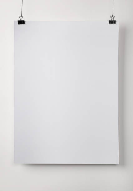 istock White blank poster hanging near light wall 1389669540