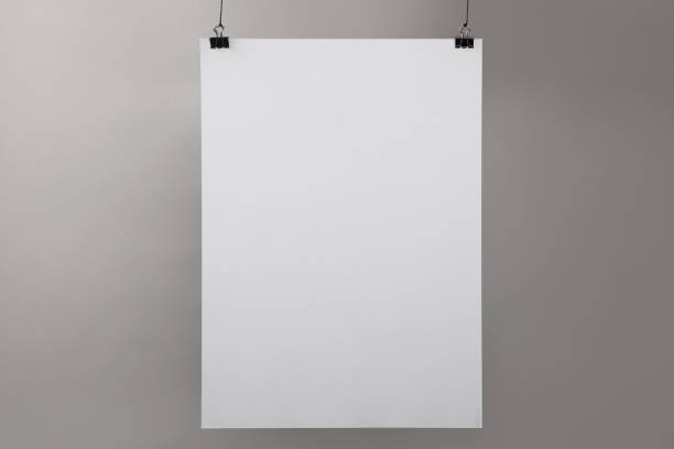 istock White blank poster hanging near grey wall 1389669688
