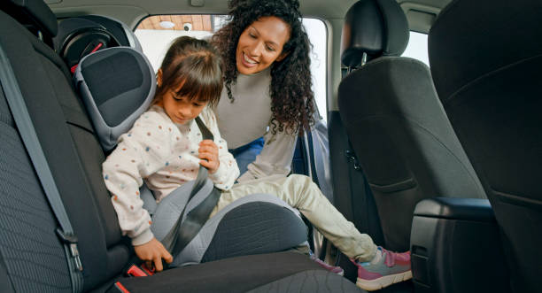 istock Daughter fastening seat belt 1389670266