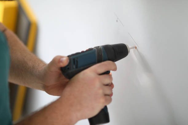 istock Hands of a man working with a screwdriver close up 1389674229