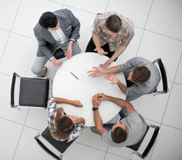 istock top view.Manager and creative team sitting at the round table 1389678484