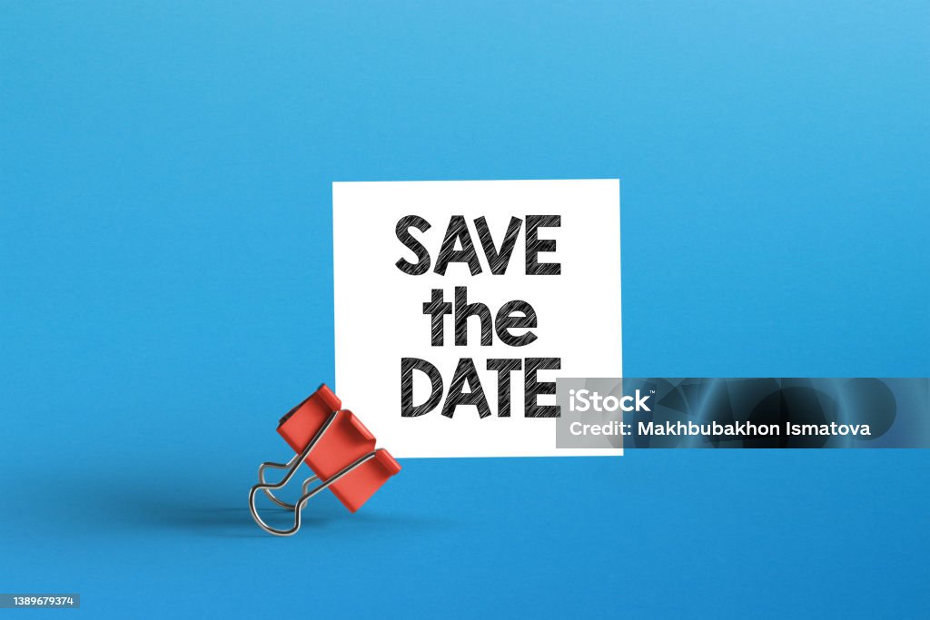 Save the date. Metal clip with note paper and save the date note Save The Date - Short Phrase Stock Photo