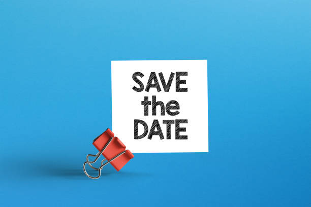 Save the date. Metal clip with note paper and save the date note stock photo