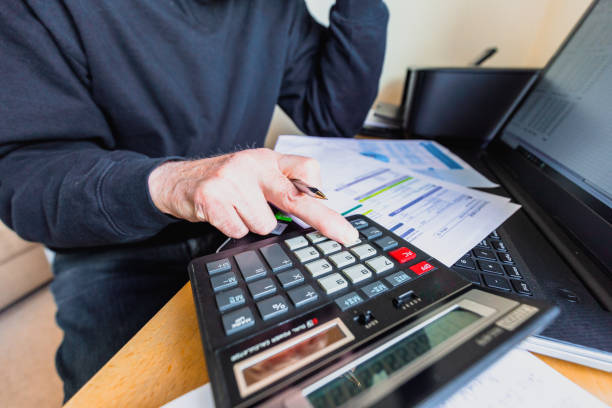 istock Worried senior man checking bills at home 1389681933