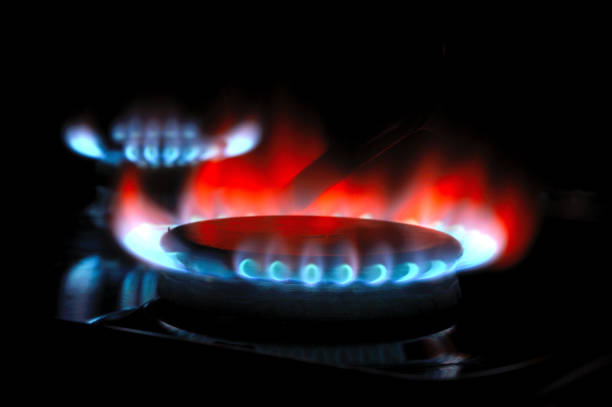 istock gas burner with burning gas. dark background. 1389683139