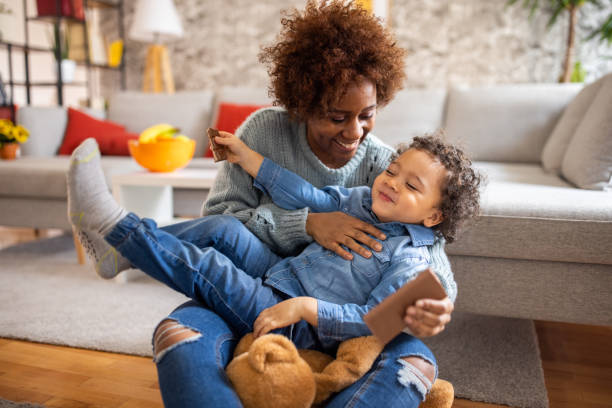 istock Funny mother and son playing together 1389683182