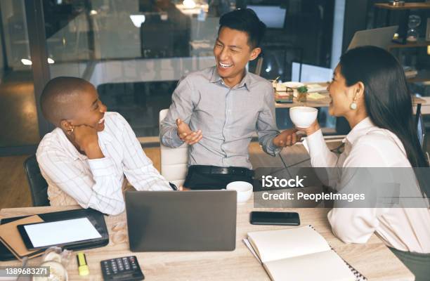 Shot Of A Group Of Businesspeople Working Late In A Modern Office Stock Photo - Download Image Now