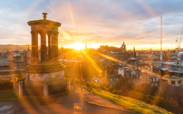 Historic Edinburgh taken from Calton Hill at dusk with lens flare Edinburgh Scotland United Kingdom stock photo