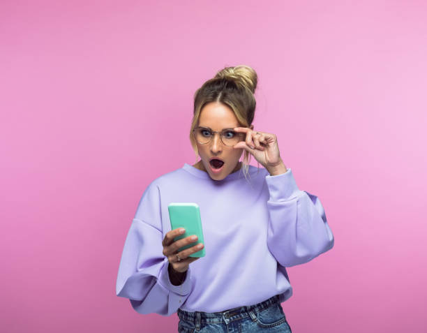 Surprised woman looking at smart phone