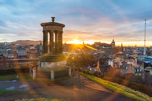 Historic Edinburgh taken from Calton Hill at dusk with lens flare Edinburgh Scotland United Kingdom