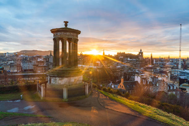 Historic Edinburgh taken from Calton Hill at dusk with lens flare Edinburgh Scotland United Kingdom stock photo