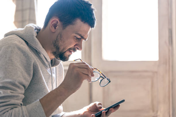 istock Serious man holding a smartphone, copy space. 1389684667
