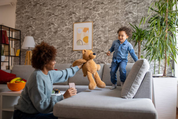 istock Mixed-race toddler boy jumping on the sofa 1389684684