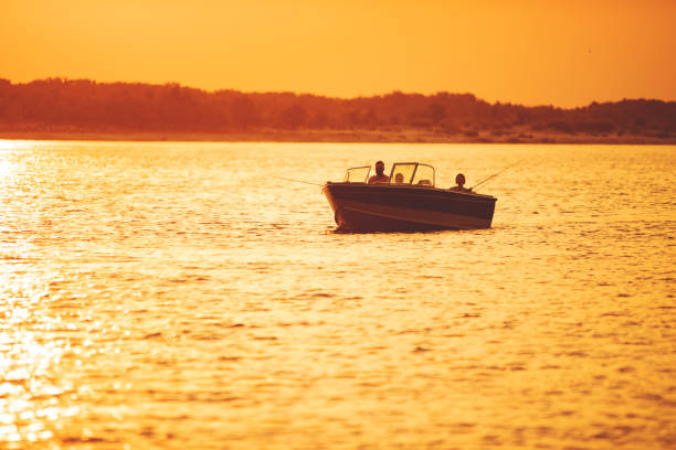 istock Speedboat with fishers at the river at sunset 1389684896