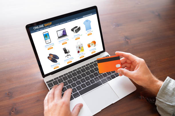 Man shopping at online store on laptop computer stock photo