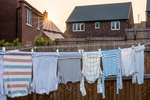 clothes rack with towels and bedlinen drying on a sunny day