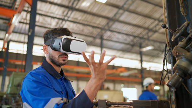 istock Engineer wearing virtual reality headset standing in the manufacturing factory. Moving hand and looking around the data. Working with Holographic Animations. High technology and industrial concept 1389684990