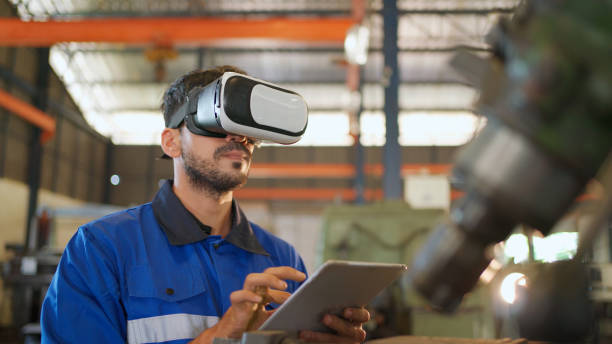 istock Engineer wearing virtual reality headset standing in the manufacturing factory. Moving hand and looking around the data. Working with Holographic Animations. High technology and industrial concept 1389685001
