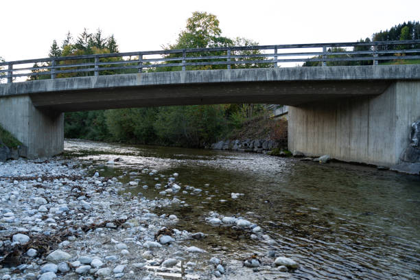 istock Small concrete bridge over a river in the valley 1389687025
