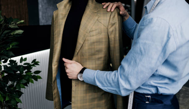 istock tailor checks the quality of suit. 1389689016