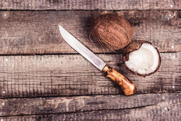 Coconut and knife on the wooden board. Coconut copy space stock photo