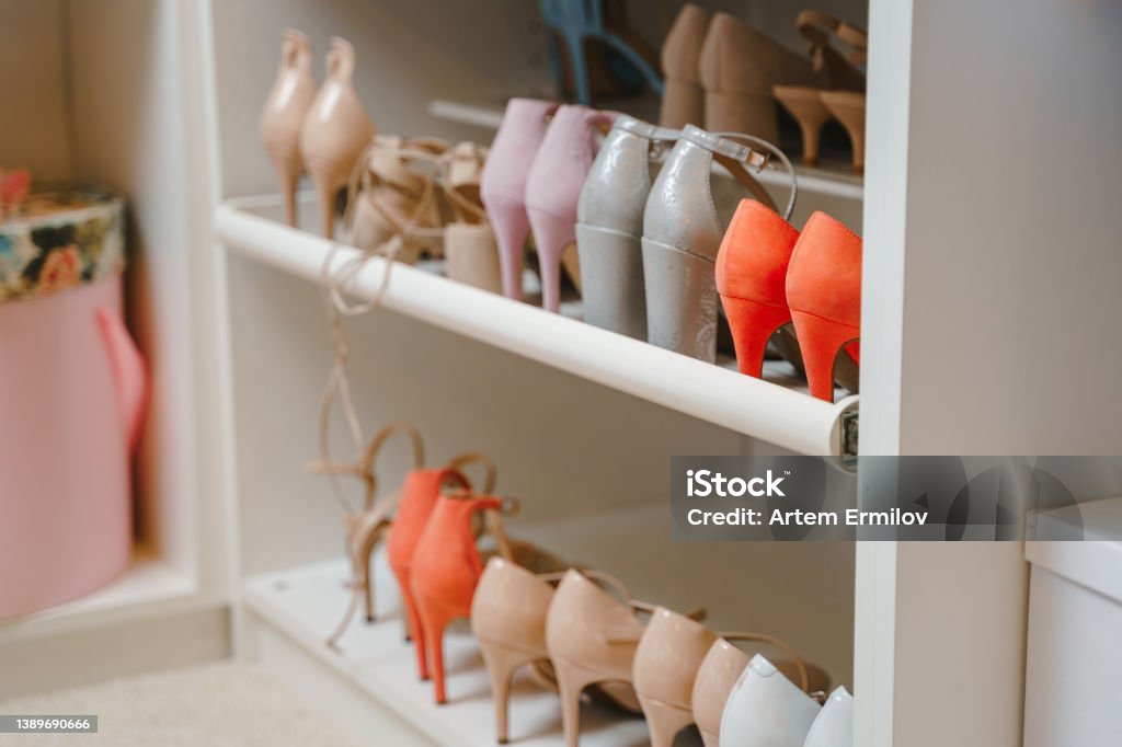 Many pairs of women's shoes on a shelf in a dressing room or showroom. Background. Shallow depth of field Many pairs of women's shoes on a shelf in a dressing room or showroom. Background. Shallow depth of field. High Heels Stock Photo