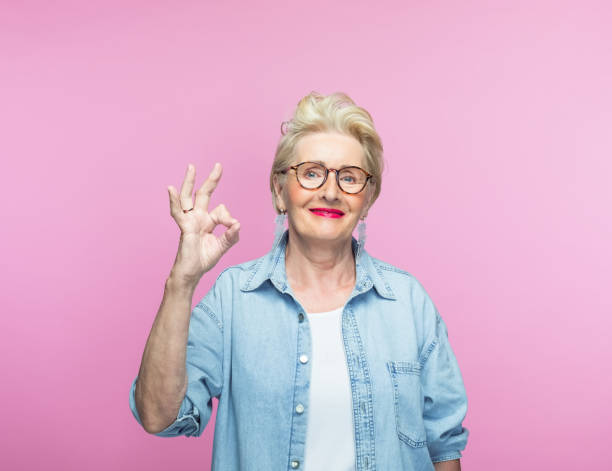 istock Elderly woman gesturing OK sign 1389691895
