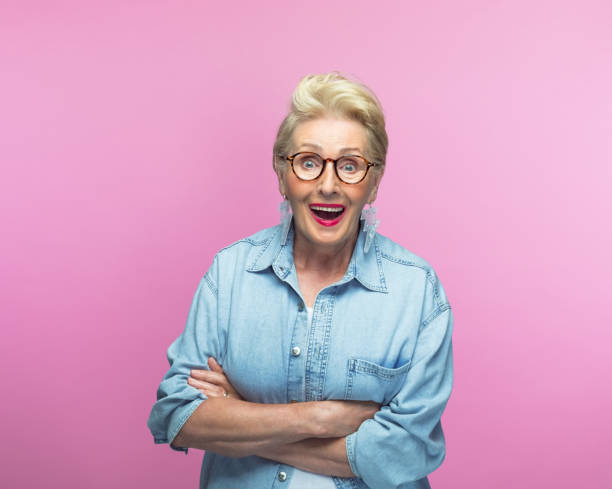 istock Surprised elderly woman in denim shirt 1389692178