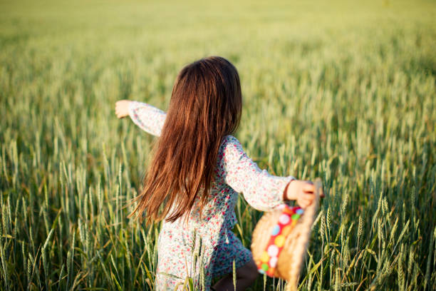 istock Little girl having fun in summer field 1389692434