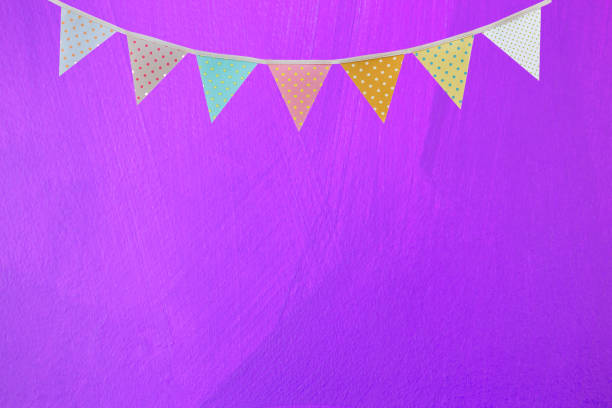 istock Flag garland on bstract blank purple wall texture background 1389693877